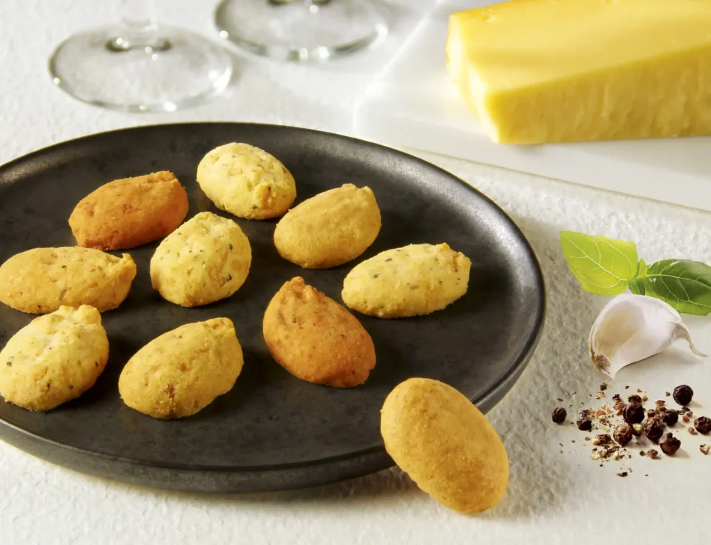 Noble kjeks som ligger på en svar allerken. en ost ligger i bakgrunnen og en hvirløk på siden.